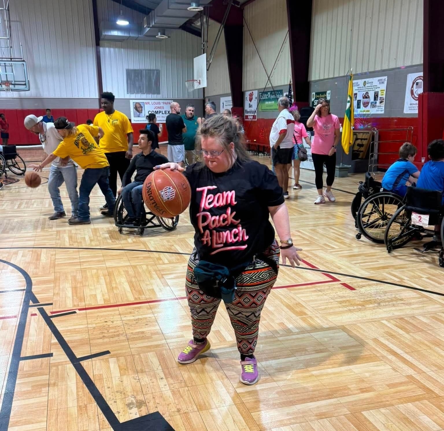 Adaptive athlete celebrating with arms raised